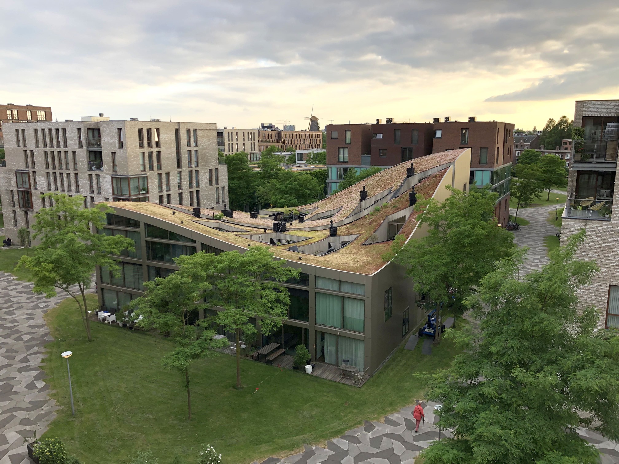 Aerial view of Blok K / Verdana in Funenpark, Amsterdam, with an undulating green roof and surrounding housing blocks.
